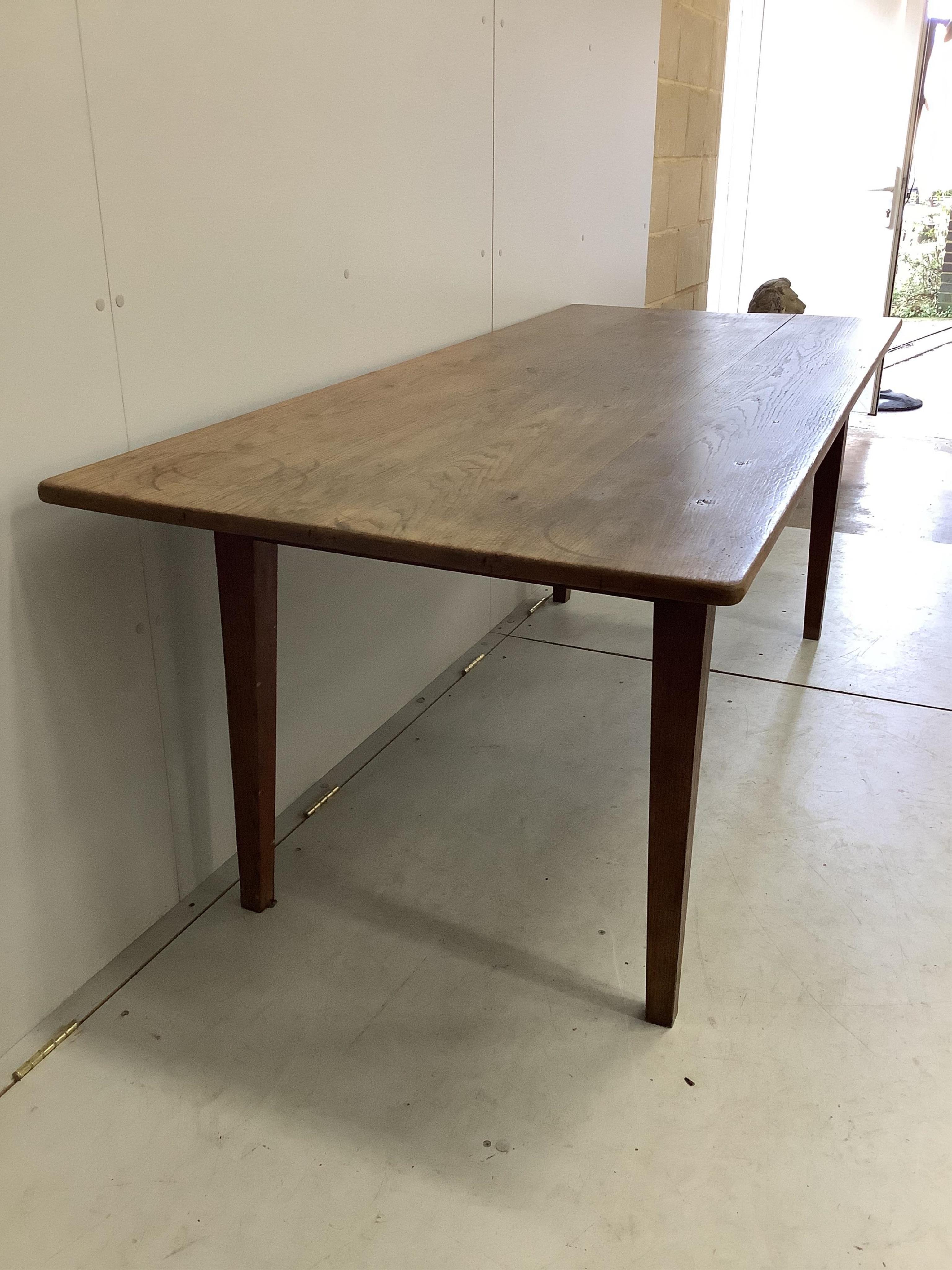 A 19th century French oak rectangular kitchen table, width 198cm, depth 82cm, height 73cm. Condition - fair